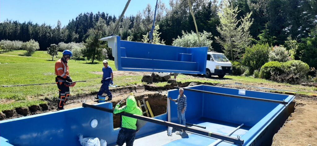 An in-ground fibreglass pool being installed
