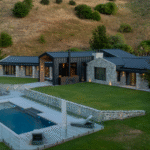 Modern Bermuda pool with sleek design, outdoor lounge area, and lush green landscaping for luxury backyard comfort. Perfect for entertaining and relaxation.