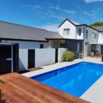 Modern Bermuda pool with sleek design and surrounding outdoor living space in a contemporary home in Bermuda. Perfect for outdoor leisure and backyard entertainment.