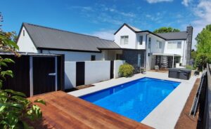 Modern Bermuda pool with sleek design and surrounding outdoor living space in a contemporary home in Bermuda. Perfect for outdoor leisure and backyard entertainment.