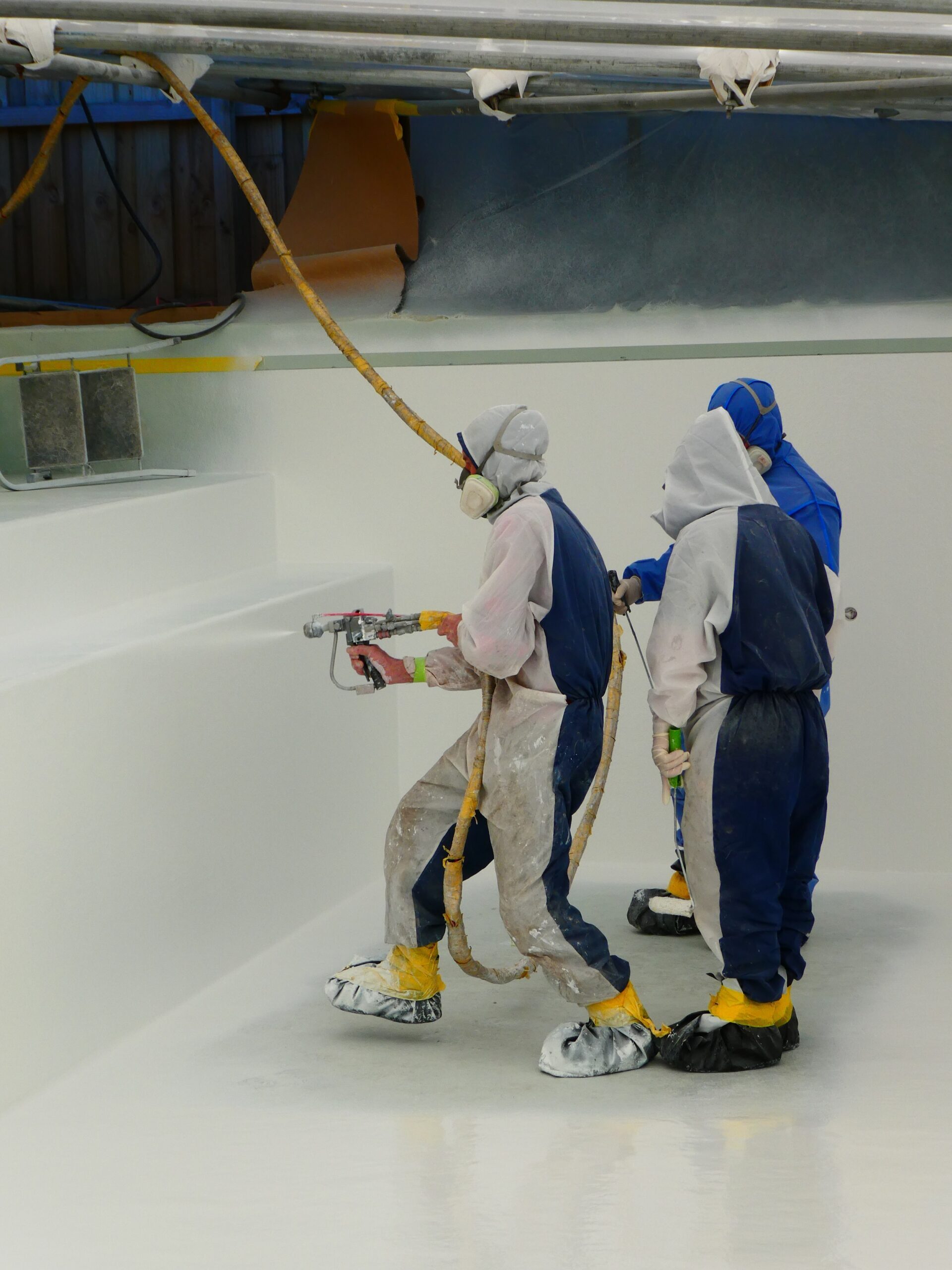 A fibreglass pool lining being applied to a concrete pool