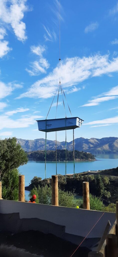 Lowering the fibreglass pool by helicopter