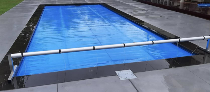 Pool cover reel on an in-ground insulated fibreglass pool